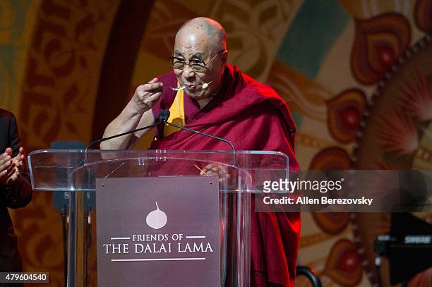 His Holiness the Dalai Lama eats his cake during his 80th birthday celebration and Global Compassion Summit at Honda Center on July 5, 2015 in...
