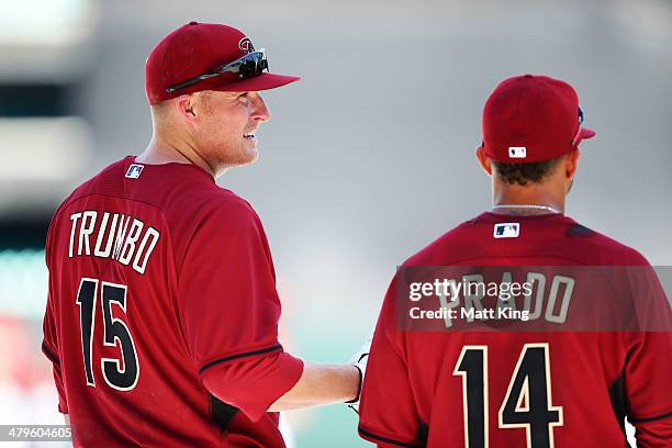 Mark Trumbo speaks to Martin Prado during an Arizona Diamondbacks MLB training session at Sydney Cricket Ground on March 20, 2014 in Sydney,...