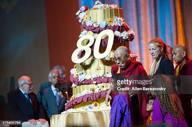 His Holiness the Dalai Lama celebrates onstage during His Holiness the 14th Dalai Lama's 80th birthday and Global Compassion Summit at Honda Center...