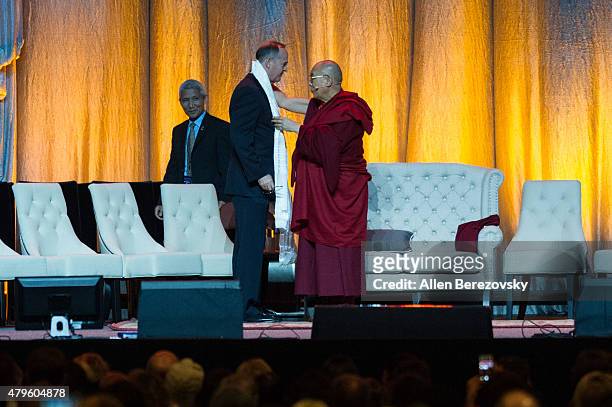 His Holiness the Dalai Lama presents a white scarf of peace to Anahemi Mayor Tom Tait onstage during His Holiness the 14th Dalai Lama's 80th birthday...