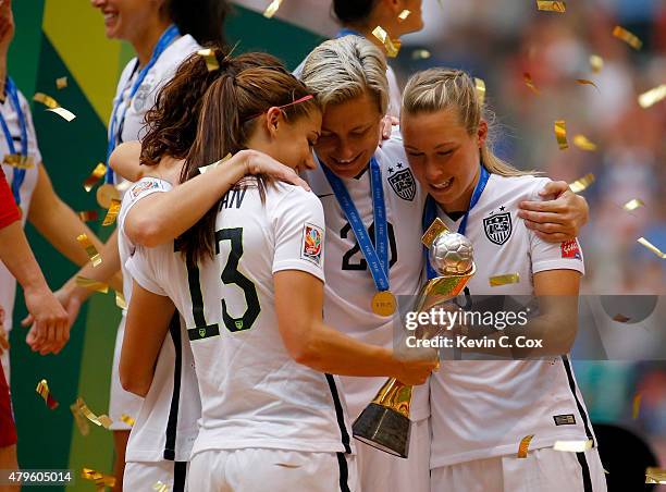 Alex Morgan, Lauren Holiday, Abby Wambach and Whitney Engen of the United States of America hold the World Cup Trophy after their 5-2 win over Japan...