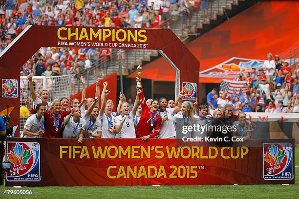 The United States poses for pictures with the World Cup Trophy after their 5-2 win over Japan in the FIFA Women's World Cup Canada 2015 Final at BC...