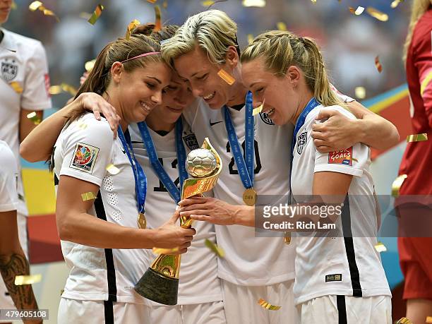 Alex Morgan, Lauren Holiday, Abby Wambach and Whitney Engen of the United States of America hold the World Cup Trophy after their 5-2 win over Japan...