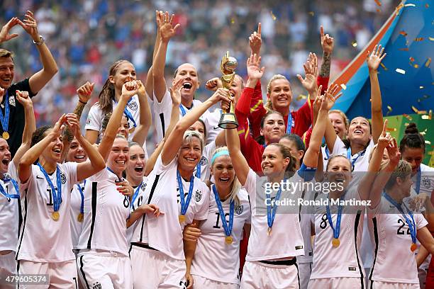 Abby Wambach and Christie Rampone of the United States of America hold the World Cup Trophy after their 5-2 win over Japan in the FIFA Women's World...