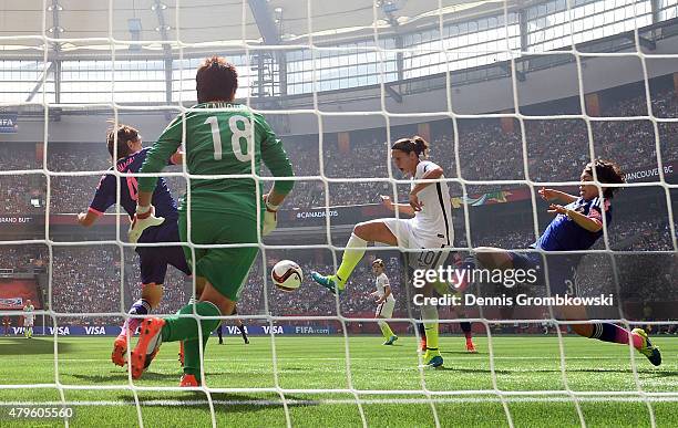 Carli Lloyd of the United States of America scores the team's second goal against Saki Kumagai, Azusa Iwashimizu and goalkeeper Ayumi Kaihori of...