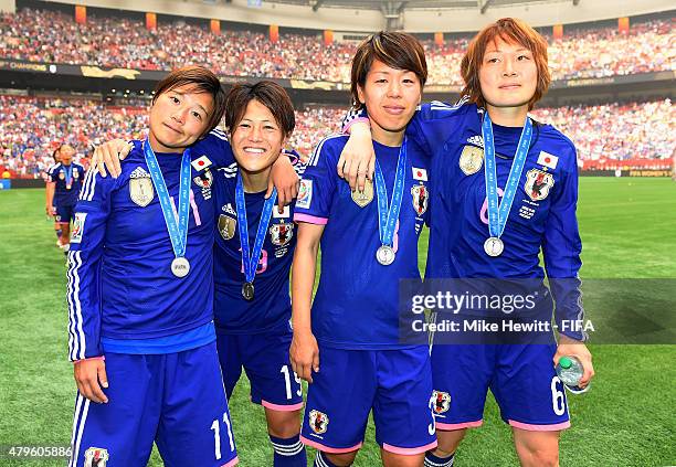 Shinobu Ohno, Saori Ariyoshi, Azusa Iwashimizu and Mizuho Sakaguchi of Japan hide their disappointment after defeat in FIFA Women's World Cup 2015...