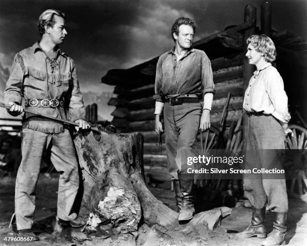 American actors Alan Ladd , as Shane, Van Heflin as Joe Starrett, and Jean Arthur as Marian Starrett, in 'Shane', directed by George Stevens, 1953.