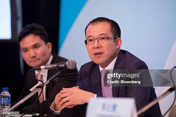 Martin Lau, president of Tencent Holdings Ltd., right, speaks as James Mitchell, chief strategy officer, left, looks on during a news conference in...