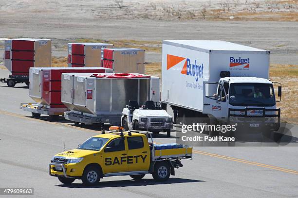 Truck arrives with luggage next to the Aeronexus Corporation's - Boeing 767 used by the Rolling Stones while being prepared in readiness for takeoff...