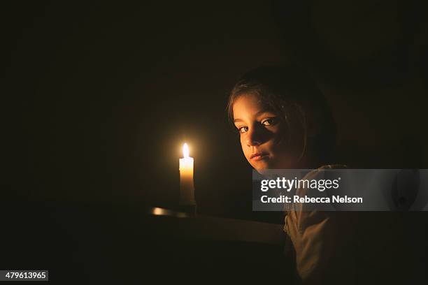 girl, with intense gaze, by candlelight - candle light stock pictures, royalty-free photos & images