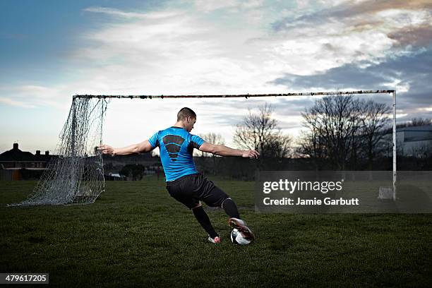 mixed race male taking a penalty kick - kicking goal stock pictures, royalty-free photos & images