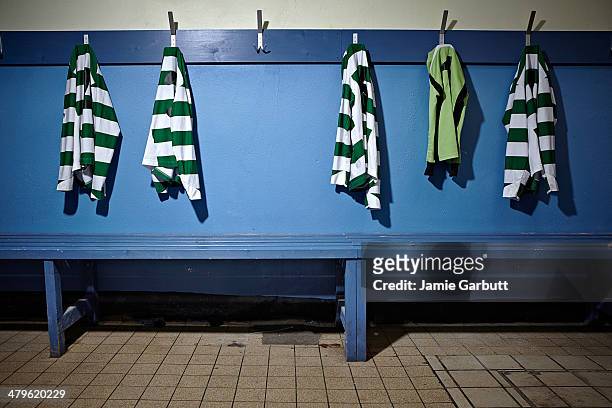 a empty changing room with football strips - locker stockfoto's en -beelden