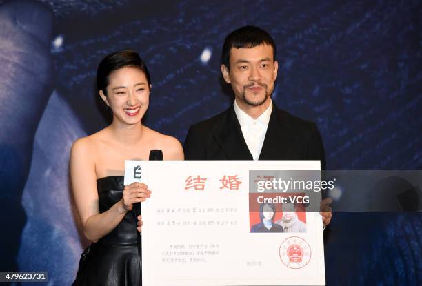 Liao Fan and Kwai Lun Mei hold a marriage certificate of the characters they played in the film "Black Coal, Thin Ice" as they attend the premiere...