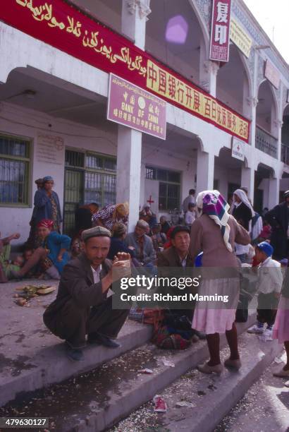 Uighur people at the entrance to the Kashgar Sunday Market. Kashgar is an ancient city that used to be an important Caravanserai on the Silk Road....