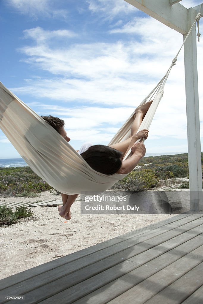 A couple sleeping in a hammock