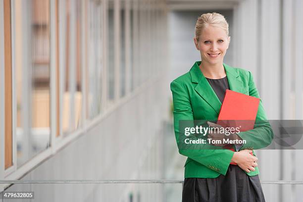 businesswoman holding file - holding book stock pictures, royalty-free photos & images