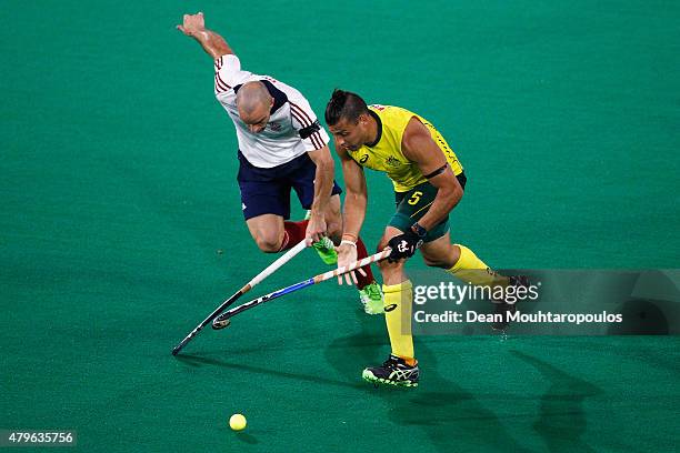 Chris Ciriello of Australia gets past Nick Catlin of Great Britain during the Fintro Hockey World League Semi-Final match between Australia and Great...