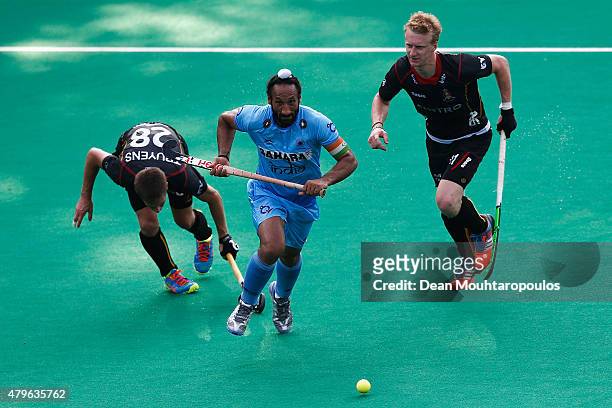 Sardar Singh of India gets past the Jerome Truyens and Amaury Keusters of Belgium during the Fintro Hockey World League Semi-Final match between...