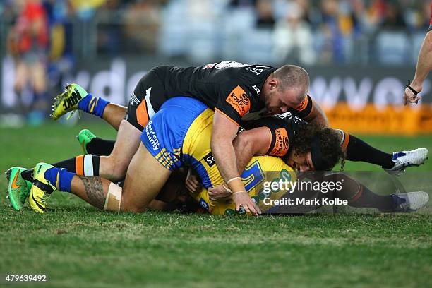 Bureta Faraimo of the Eels is tackled during the round 17 NRL match between the Wests Tigers and the Parramatta Eels at ANZ Stadium on July 6, 2015...