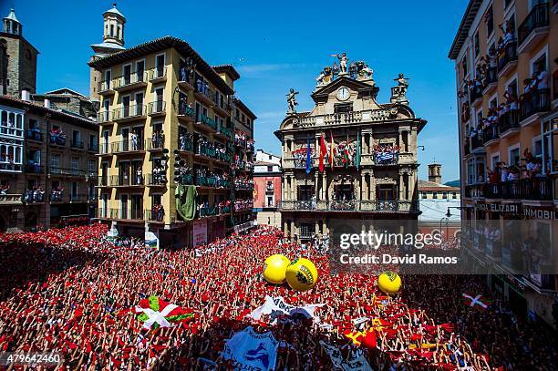 Revellers hold up their red handkerchiefs during the opening day or 'Chupinazo' of the San Fermin Running of the Bulls fiesta on July 6, 2015 in...