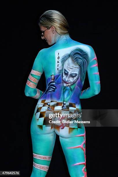 Participant poses with her body paintings designed by bodypainting artist Torsten Winter from Germany, in the 2015 World Bodypainting Festival on...