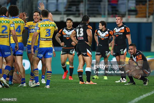 Luke Kelly of the Eels celebrates with his team mates after Semi Radradra of the Eels scored a try as Martin Taupau and Dene Halatau of the Wests...
