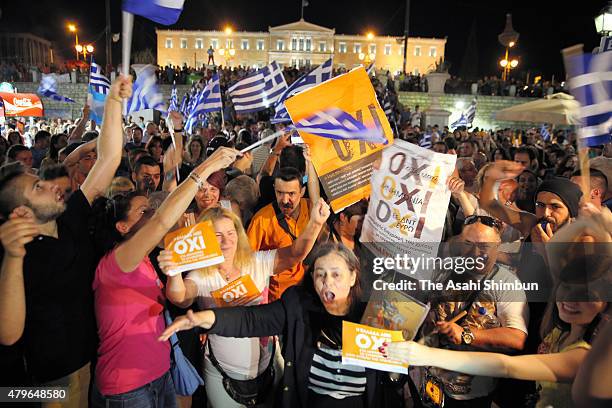 Eople celebrate in front of the Greek parliament as the people of Greece reject the debt bailout by creditors on July 6, 2015 in Athens, Greece. The...