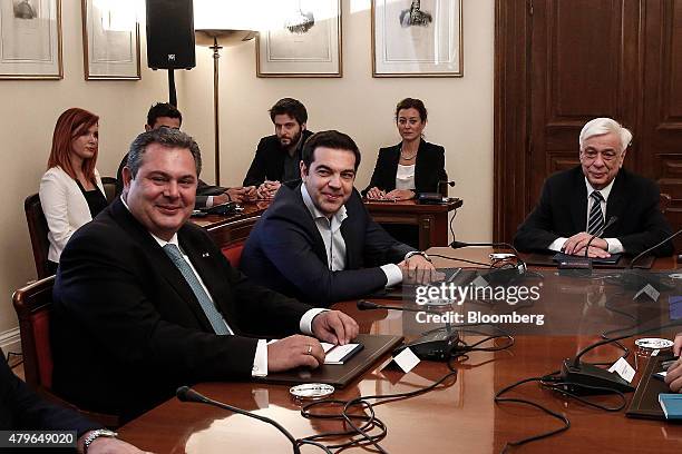 Alexis Tsipras, Greece's prime minister, center, sits with Panos Kammenos, leader of the Independent Greeks party, left, and Prokopis Pavlopoulos,...