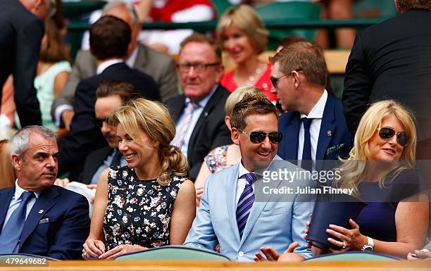 Paul McGinley, wife Alison McGinley, Ian Poulter and wife Katie Poulter on Centre Court for the Ladies' Singles Fourth Round match between Serena...