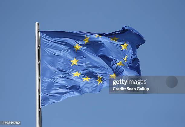 The flag of the European Union flies over the Reichstag the day after a majority of people voted "no" in the Greek referendum on July 6, 2015 in...