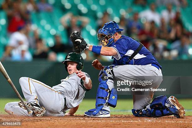 Mike Walker of Australia is tagged out on home plate by A.J. Ellis of the Dodgers during the match between Team Australia and the LA Dodgers at...