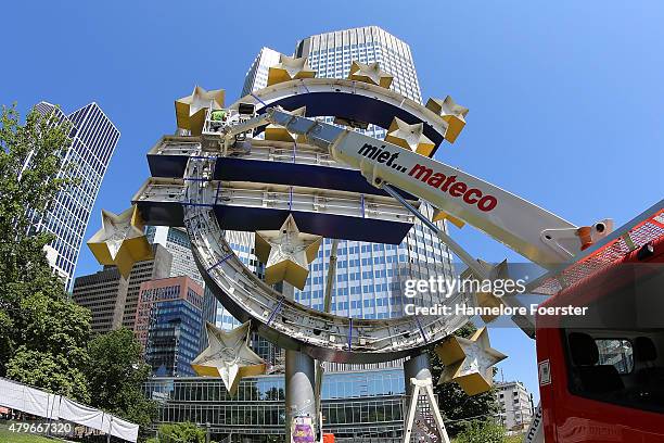 The Euro sculpture, near the old ECB headquarters, undergoes maintenance on July 6, 2015 in Frankfurt, Germany. The DAX dropped slightly in the...