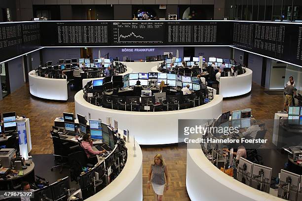 Traders on the trading floor of the Frankfurt Stock Exchange as a graph shows the day's performance of the DAX index the day after the 'NO' vote in...