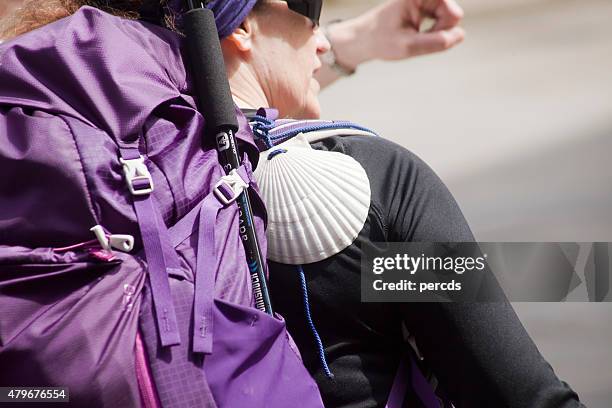 pilgrim with rucksack and scallop in the "camino de santiago" - camino de santiago stock pictures, royalty-free photos & images