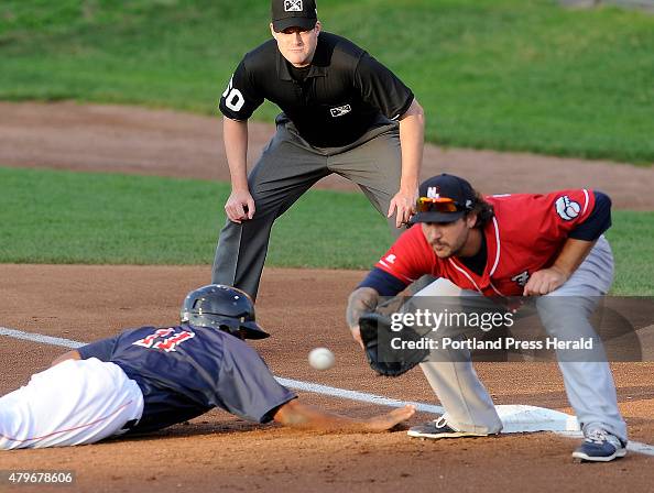 1st base umpire John Bacon keeps his eye on the ball as Portland