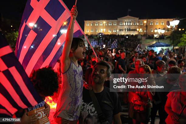 People celebrate in front of the Greek parliament as the people of Greece reject the debt bailout by creditors on July 6, 2015 in Athens, Greece. The...