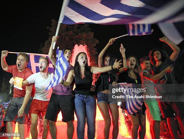 People celebrate in front of the Greek parliament as the people of Greece reject the debt bailout by creditors on July 6, 2015 in Athens, Greece. The...