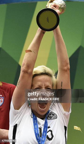 Midfielder Megan Rapinoe holds the trophy as she celebrates with teammates after their victory in the final football match between USA and Japan...