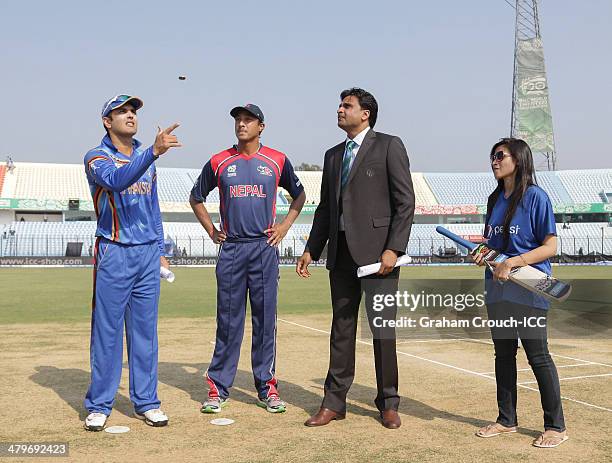 Mohammad Nabi , captain of Afghanistan and Paras Khadka captain of Nepal at the coin toss with match referee Javagal Srinath and pepsi mascot Faria...