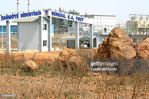 Picture shows the entrance of the Dangote Industries cement plant under construction in Pout, some 50 km from Dakar, on February 6, 2014. The...