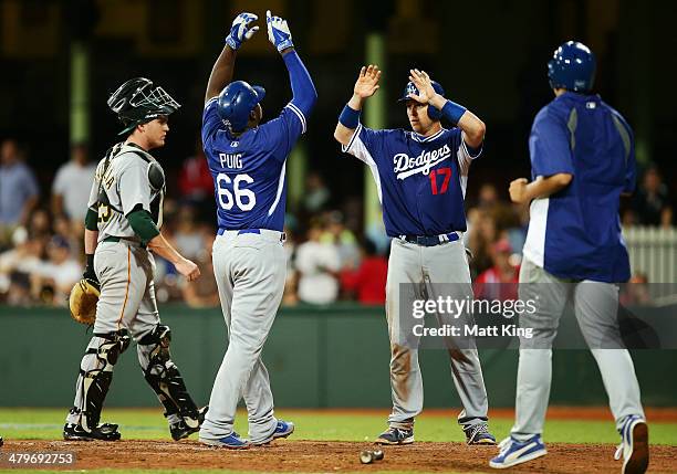 Yasiel Puig of the Dodgers celebrates with A. J. Ellis after hitting a two run home run in the seventh inning during the match between Team Australia...