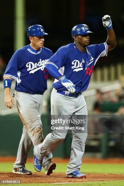 Yasiel Puig of the Dodgers celebrates with A. J. Ellis after hitting a two run home run in the seventh inning during the match between Team Australia...