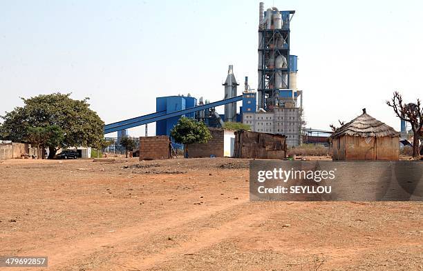 Picture shows houses near the Dangote Industries cement plant under construction in Pout, some 50 km from Dakar, on February 6, 2014. The...