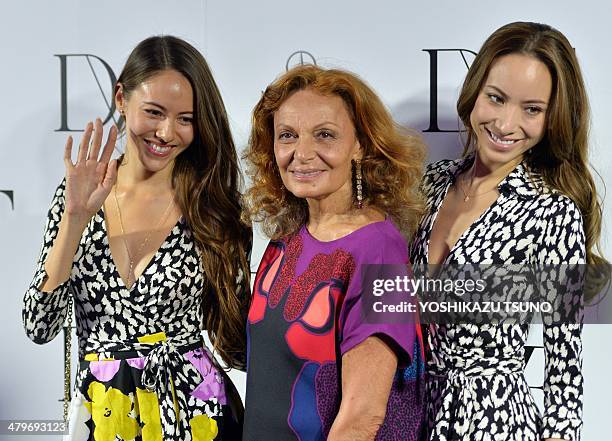 Designer Diane von Furstenberg smiles with Japanese models Jessica Michibata and Angelica Michibata after the presentation of her 2014-2015...