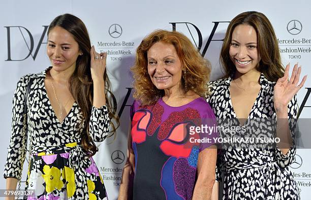 Designer Diane von Furstenberg smiles with Japanese models Jessica Michibata and Angelica Michibata after the presentation of her 2014-2015...