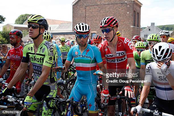 Vincenzo Nibali of Italy riding for Astana Pro Team tries to calm the peloton inculding Michael Rogers of Australia riding for Tinkoff-Saxo, Marcel...