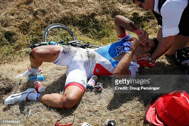 William Bonnet of France riding for FDJ is attended to after being involved in a crash with 65km remaining in stage three of the 2015 Tour de France...