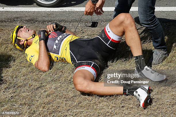 Fabian Cancellara of Switzerland riding for Trek Factory Racing in the overall race leader yellow jersey is attended to after being involved in a...