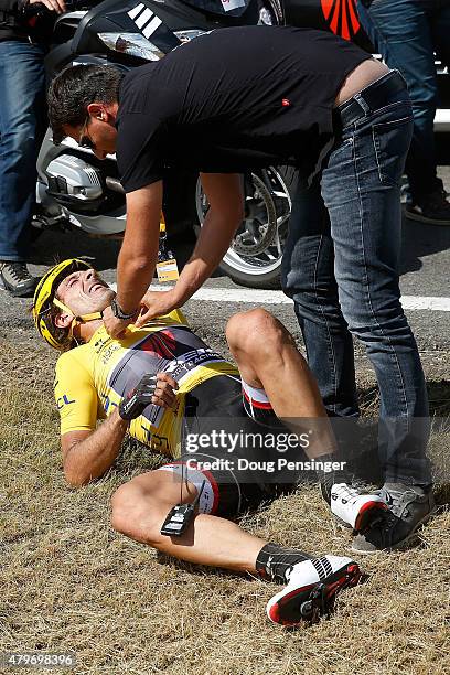 Fabian Cancellara of Switzerland riding for Trek Factory Racing in the overall race leader yellow jersey is attended to after being involved in a...