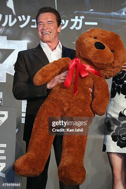 Arnold Schwarzenegger receives a teddy bear during the Tokyo Premiere of 'Terminator Genisys' at the Roppongi Hills Arena on July 6, 2015 in Tokyo,...